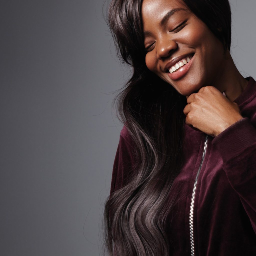 pretty black woman with long shiny hair in studio shoot